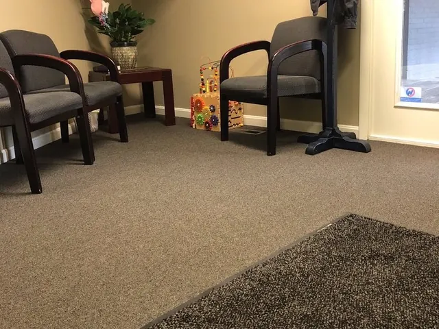 The waiting room at Hess Family Dental, Suite 1, with chairs, a plant and a toy for young children.